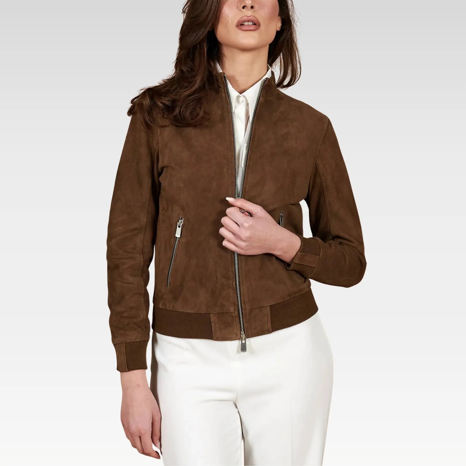 Woman wearing a brown suede jacket on a white background