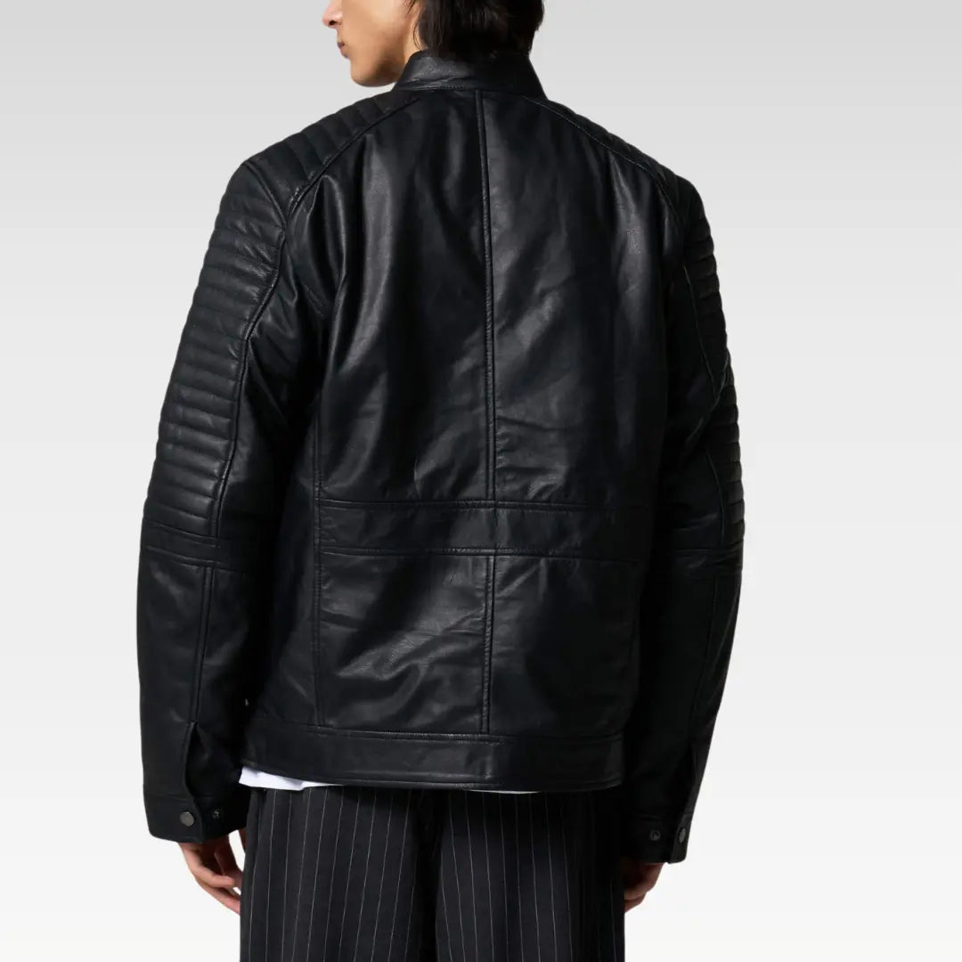 Back view of quilted leather racer jacket displaying structured stitching and minimalist racer cut.