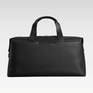 Flat-lay of black full-grain leather duffle bag with reinforced handles, luggage sleeve, and stylish, durable exterior.