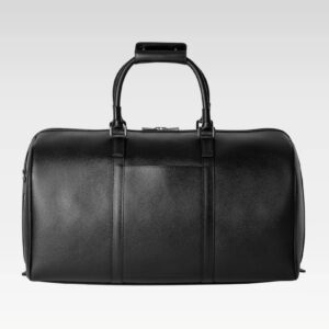 Front view of Monte leather duffel bag in black calfskin, held by hand, showing smooth texture and sleek design.