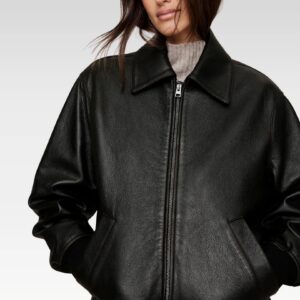Detailed view of bomber jacket’s ribbed-knit cuff and hem, emphasizing premium stitching and leather texture.