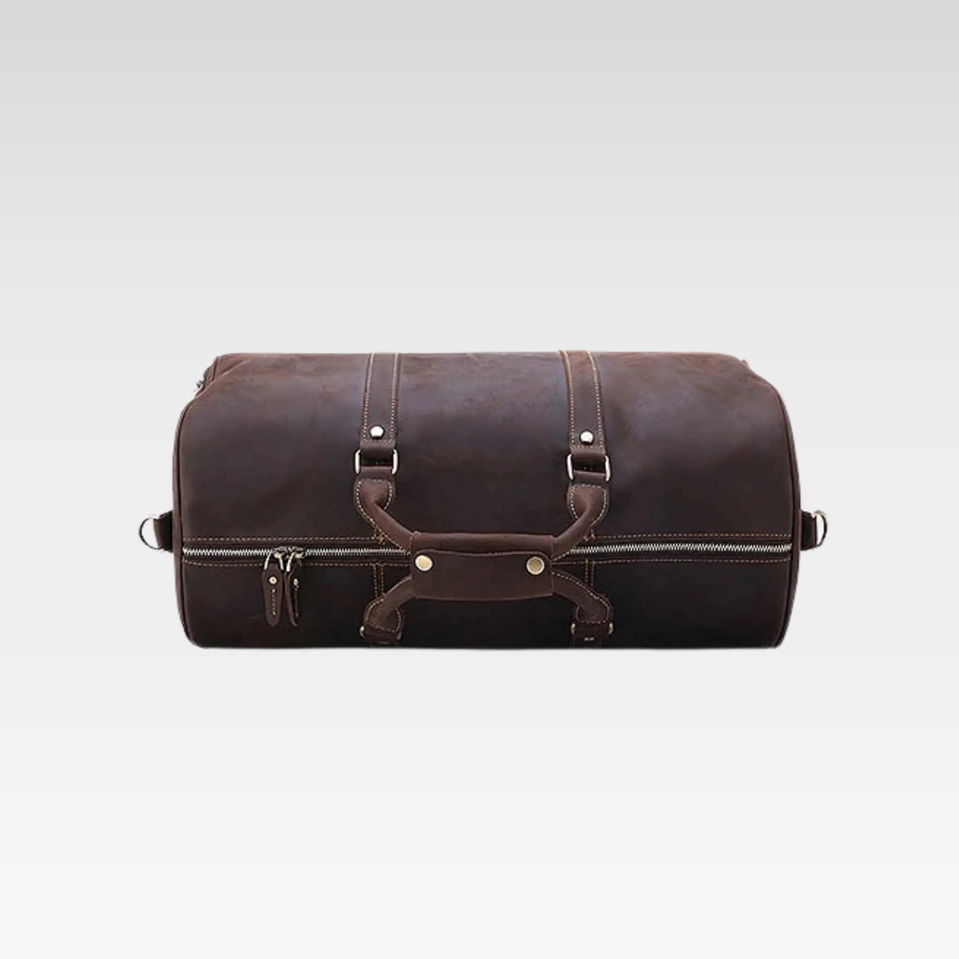 Top angled view of the leather duffle bag showing buckle hardware and premium stitching details.