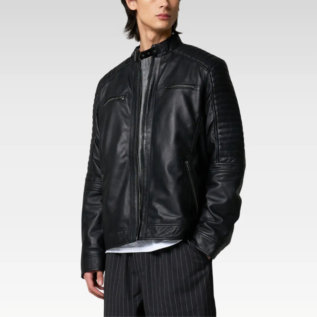 Side profile of a black leather racer jacket highlighting ribbed quilted shoulder design and slim silhouette.