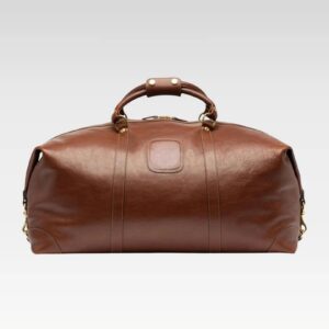 Front view of the Rogue premium full-grain leather travel duffel bag showcasing its rich brown leather and structured shape.