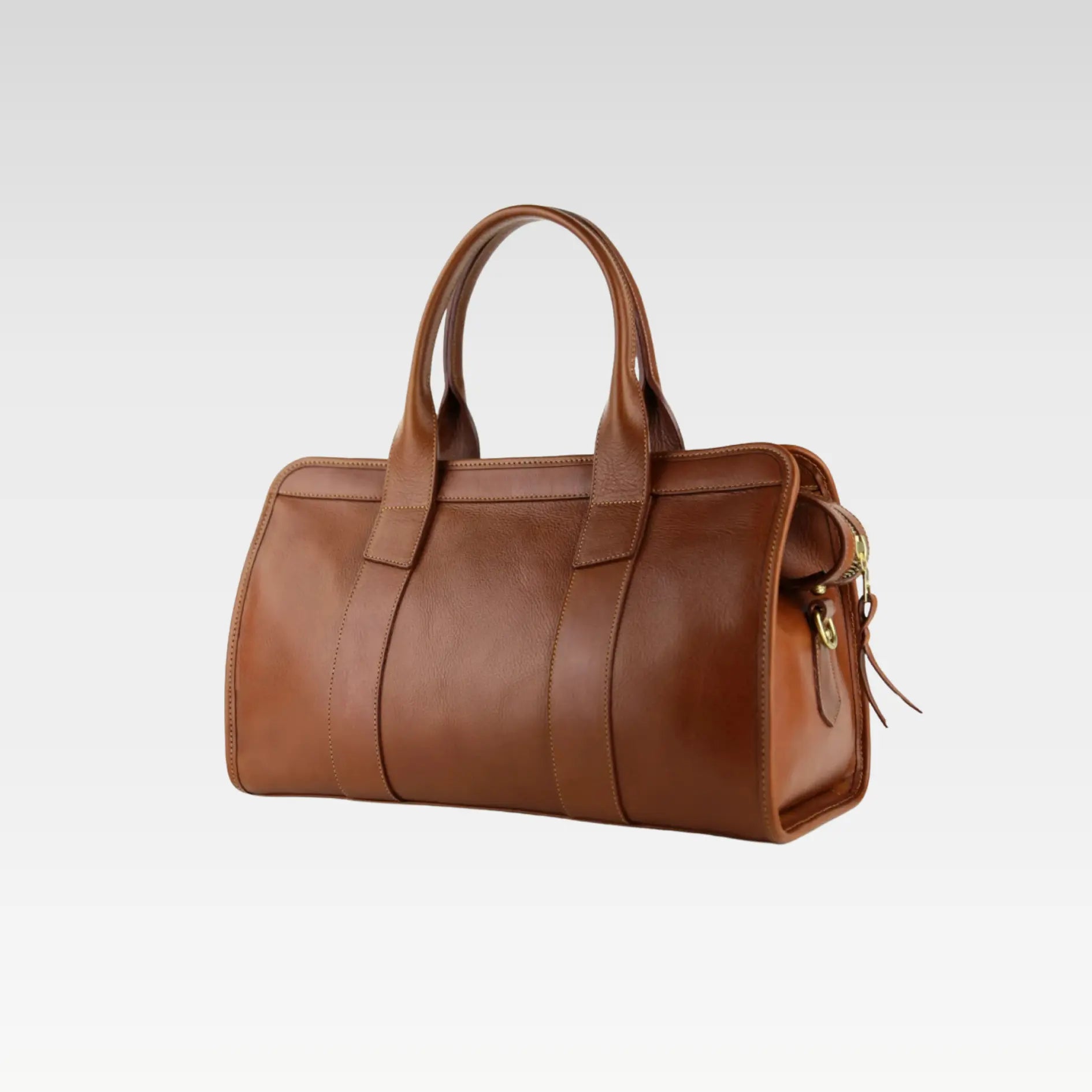Close-up side view showing the rolled handles and brass hardware of the Signature Weekender Leather Duffle in brown.