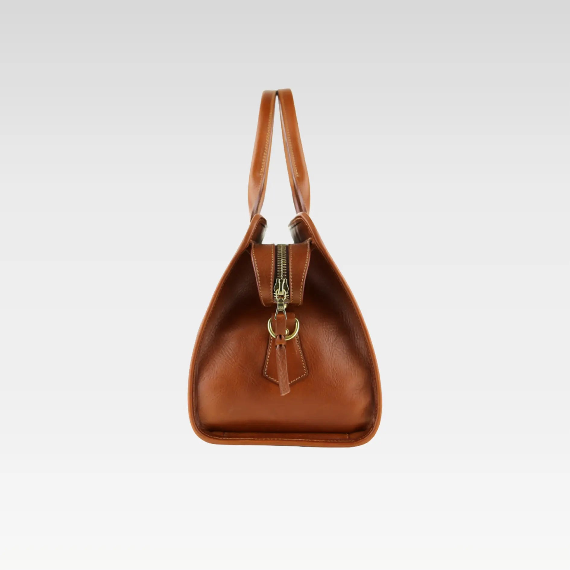 Side angle of the brown Signature Weekender Leather Duffle highlighting smooth leather craftsmanship, durable construction, and solid brass zipper.