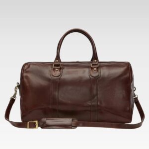 Man carrying Stratos brown full-grain leather duffle cabin bag with sturdy handles, ideal for carry-on travel