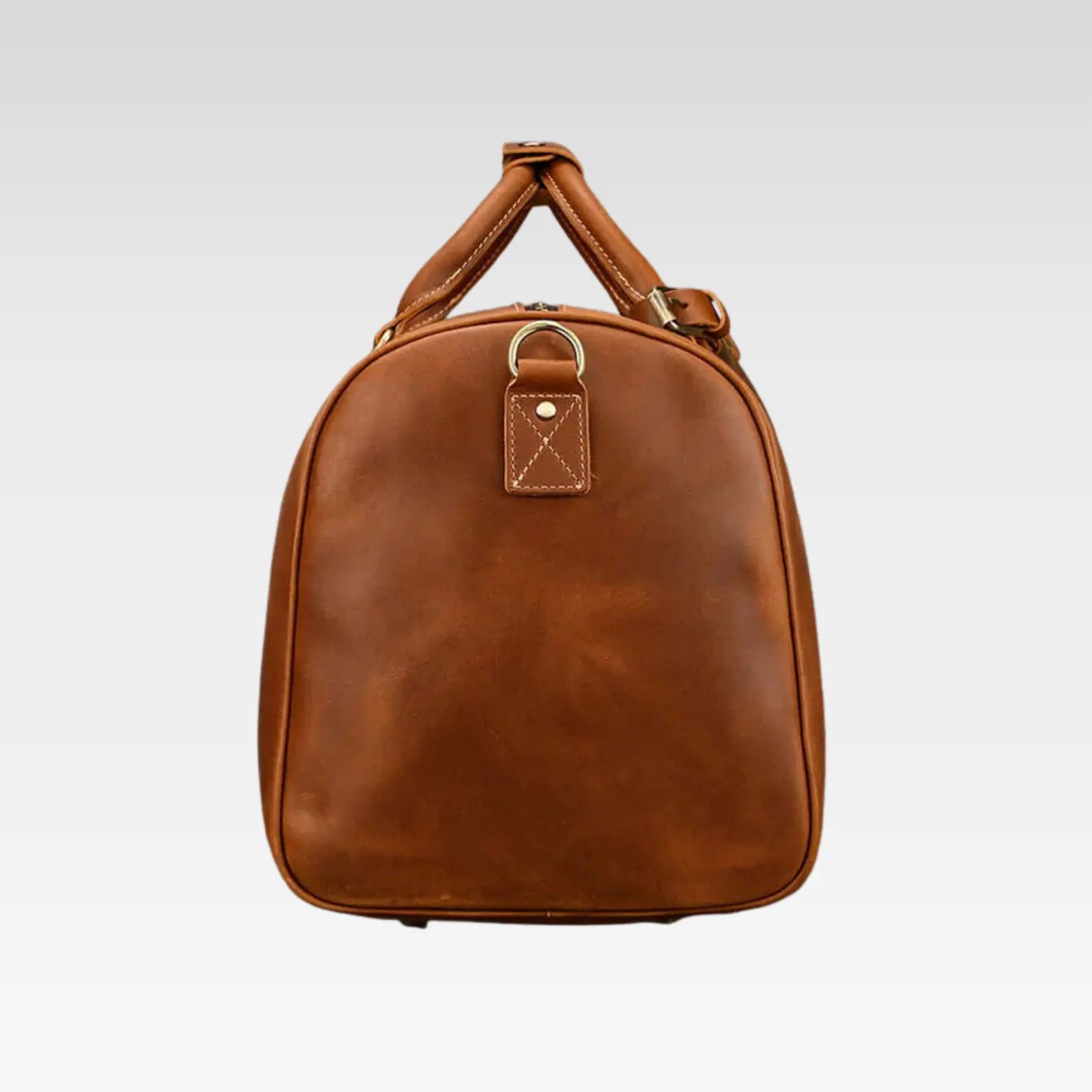 Side-angle view of The Voyager leather weekender bag displaying its structured shape and minimal travel-ready design.