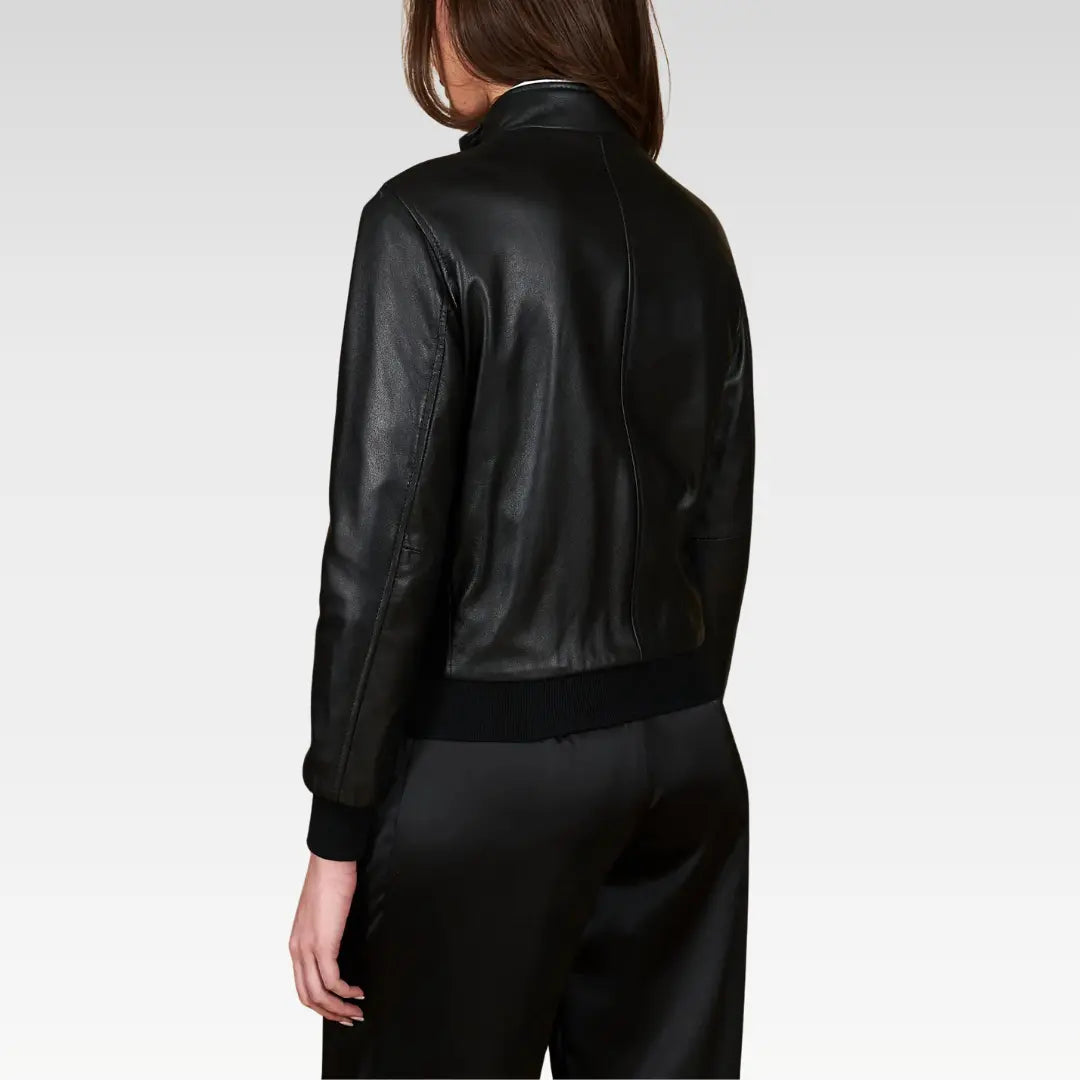 Women's cropped washed leather bomber jacket in black, displaying the back view with a modern washed finish and ribbed waistband for a timeless bomber style.