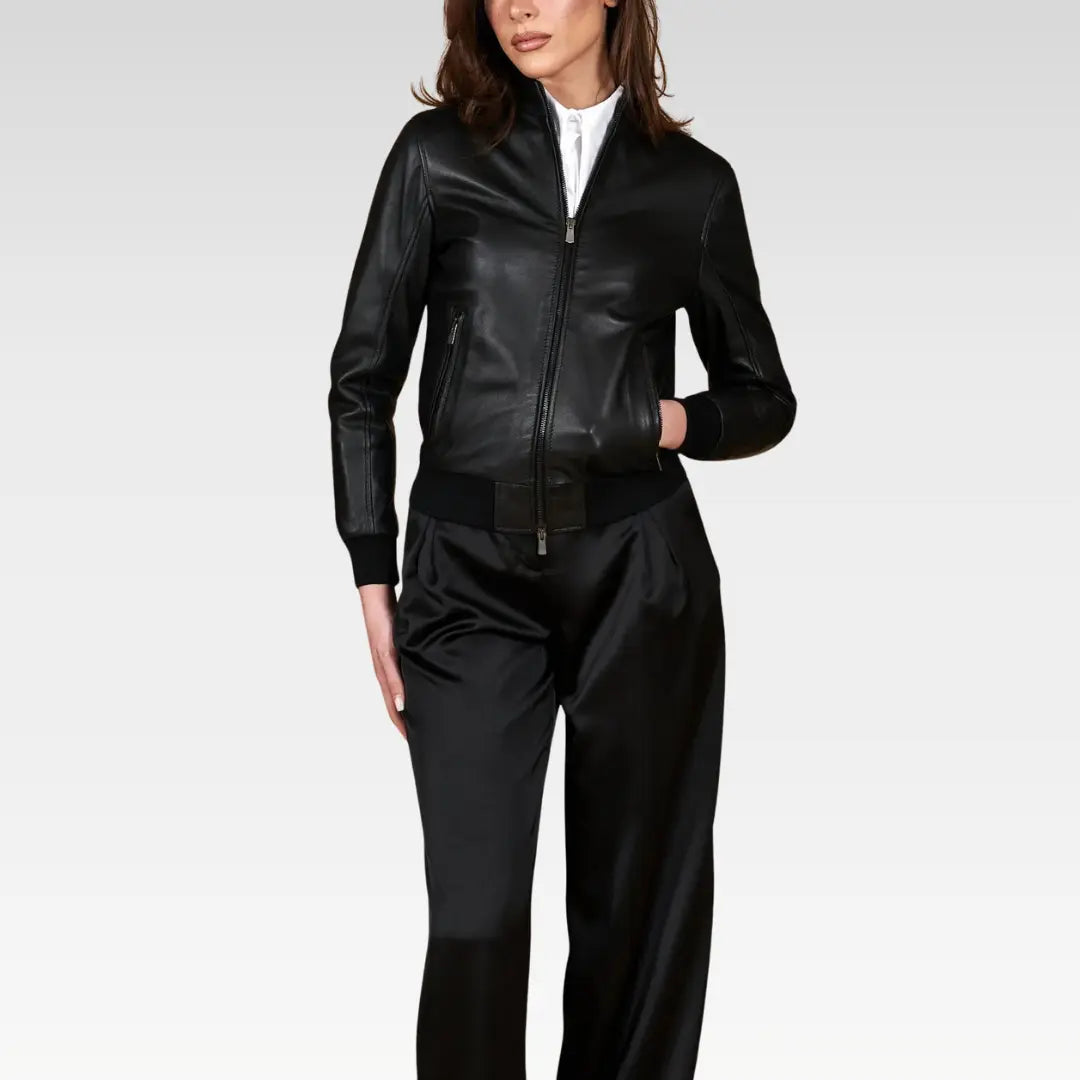 Women's cropped washed leather bomber jacket in black, side angle view emphasizing the balloon sleeves and waist-length design, made with care in audited factories.