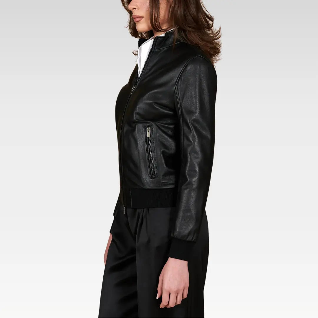 Women's cropped washed leather bomber jacket in black, side profile highlighting the balloon sleeves and cropped fit, ideal for pairing with high-rise jeans